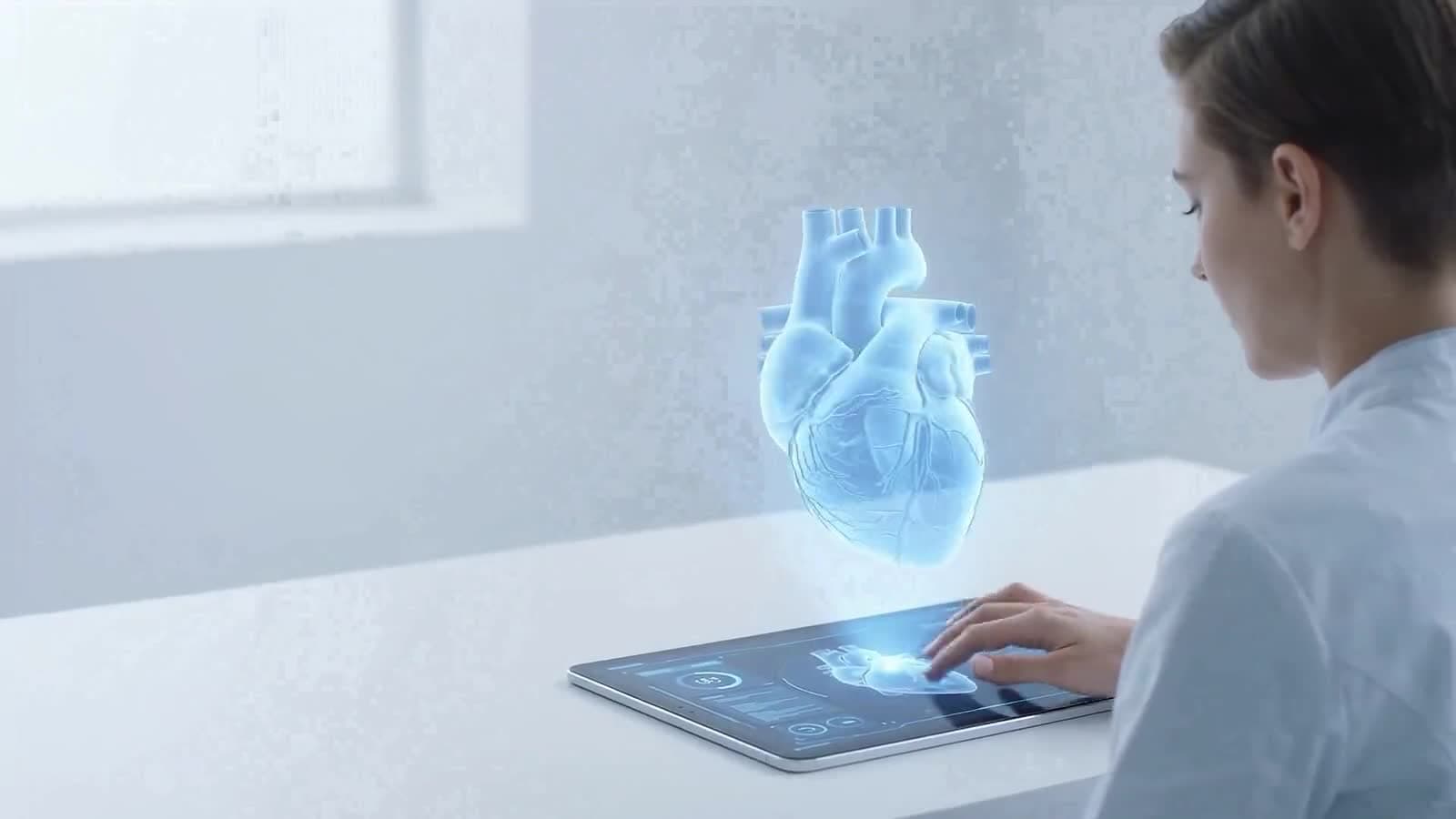 A student studying with a holographic heart on a tablet